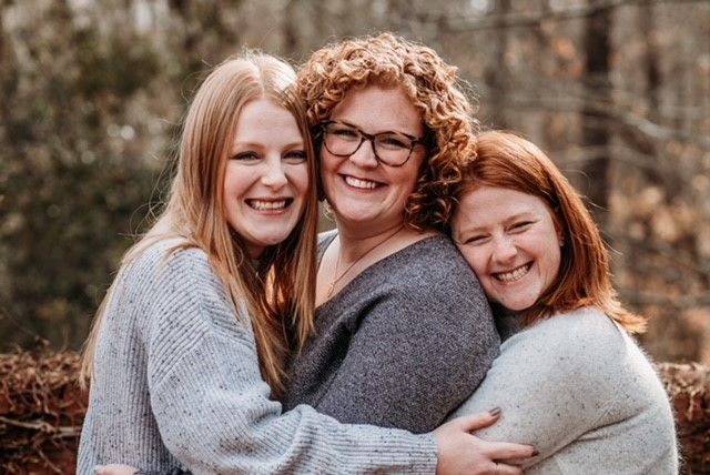 Attorney Meg Howard (left) with her older sisters, Jess and Katie.